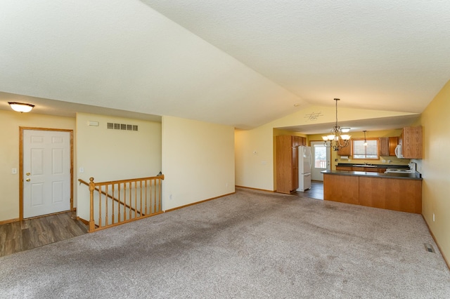 4540 Prairie View Pl NW, Rochester, MN 55901 - unfurnished living room featuring carpet, a chandelier, and vaulted ceiling