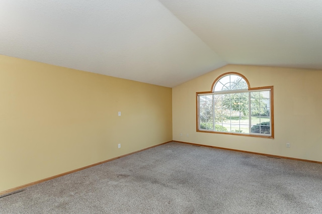 4540 Prairie View Pl NW, Rochester, MN 55901 - carpeted empty room featuring vaulted ceiling and baseboards
