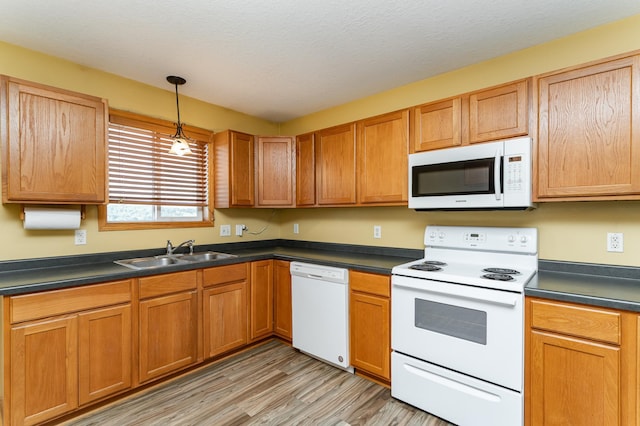 4540 Prairie View Pl NW, Rochester, MN 55901 - kitchen with white appliances, dark countertops, light wood-style floors, decorative light fixtures, and a textured ceiling