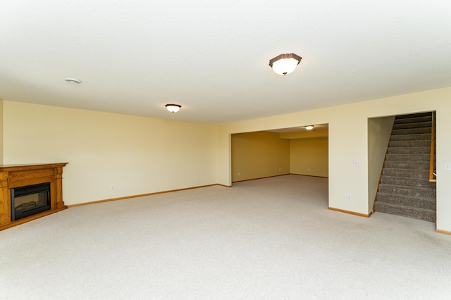 4540 Prairie View Pl NW, Rochester, MN 55901 - unfurnished living room with light carpet, stairs, and a fireplace