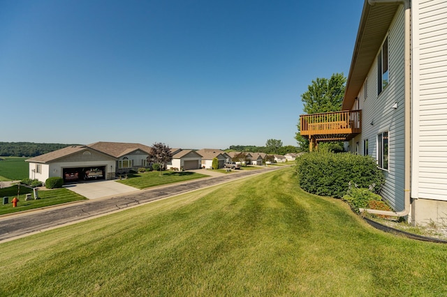 4540 Prairie View Pl NW, Rochester, MN 55901 - view of grassy yard featuring a residential view, concrete driveway, a balcony, and a garage