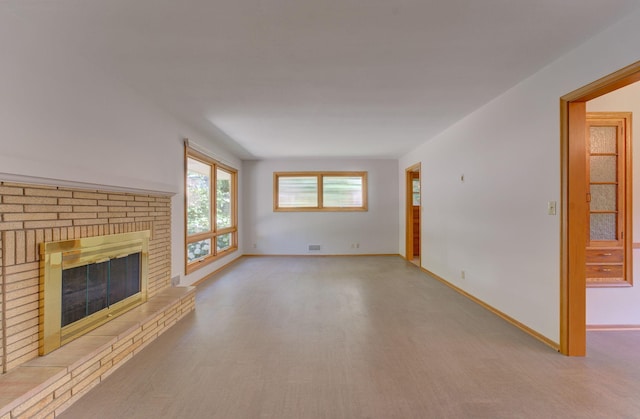 1636 9th Ave NE, Rochester, MN 55906 - unfurnished living room with a brick fireplace and wood finished floors