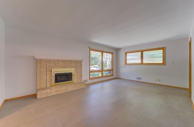 1636 9th Ave NE, Rochester, MN 55906 - unfurnished living room featuring a brick fireplace and light colored carpet