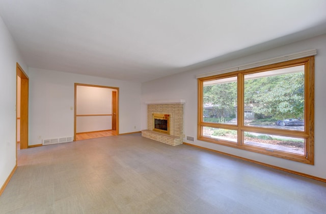 1636 9th Ave NE, Rochester, MN 55906 - unfurnished living room featuring a brick fireplace and carpet