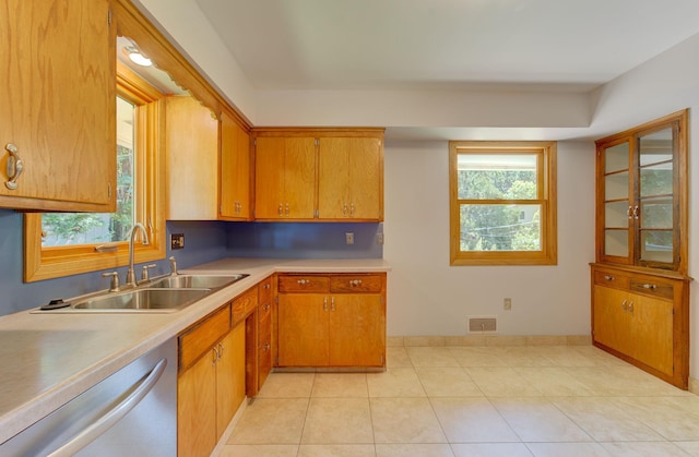 1636 9th Ave NE, Rochester, MN 55906 - kitchen featuring dishwasher, light countertops, brown cabinetry, and light tile patterned flooring