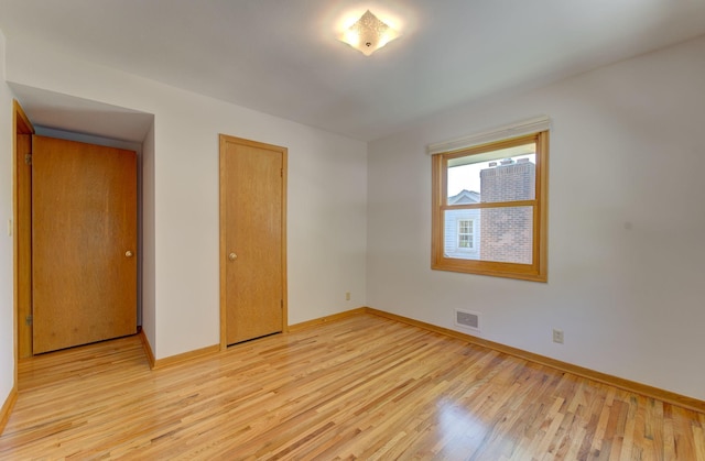 1636 9th Ave NE, Rochester, MN 55906 - unfurnished bedroom featuring light wood-type flooring and a closet