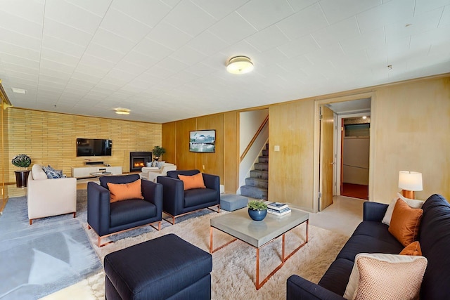 1636 9th Ave NE, Rochester, MN 55906 - living room featuring stairway, a warm lit fireplace, and wooden walls