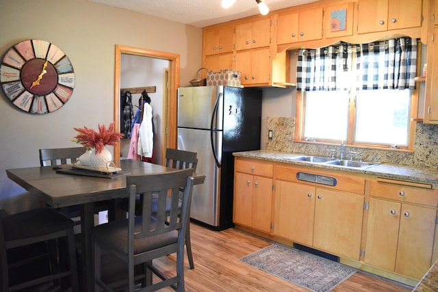 16014 240th St, Cold Spring, MN 56320 - kitchen featuring freestanding refrigerator, tasteful backsplash, and light countertops