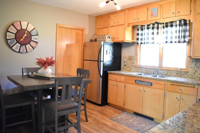16014 240th St, Cold Spring, MN 56320 - kitchen with freestanding refrigerator, decorative backsplash, light wood-type flooring, and light countertops