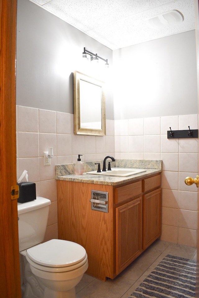 16014 240th St, Cold Spring, MN 56320 - bathroom featuring tile walls, vanity, tile patterned floors, and wainscoting