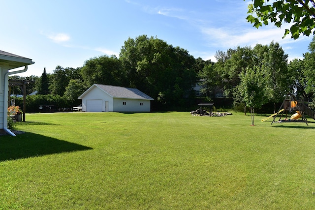 16014 240th St, Cold Spring, MN 56320 - view of grassy yard featuring a detached garage, a playground, and an outdoor structure