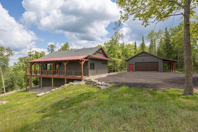 2018 County 5 NW, Hackensack, MN 56452 - view of front of home featuring a detached garage, an outbuilding, and a front yard
