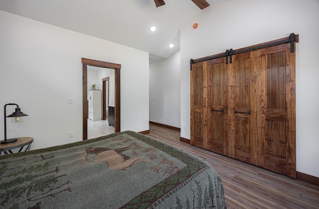 2018 County 5 NW, Hackensack, MN 56452 - bedroom featuring wood finished floors, a barn door, a ceiling fan, recessed lighting, and beam ceiling