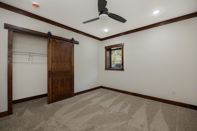 2018 County 5 NW, Hackensack, MN 56452 - unfurnished bedroom featuring a barn door, light carpet, a ceiling fan, a closet, and recessed lighting