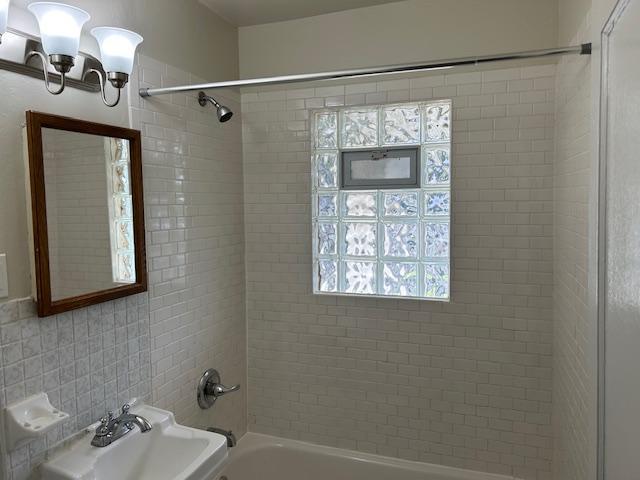 1464 Sheldon St, Saint Paul, MN 55108 - bathroom with bathing tub / shower combination and a chandelier