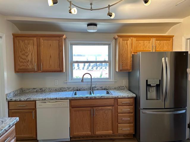 1464 Sheldon St, Saint Paul, MN 55108 - kitchen featuring stainless steel fridge with ice dispenser, white dishwasher, and brown cabinetry