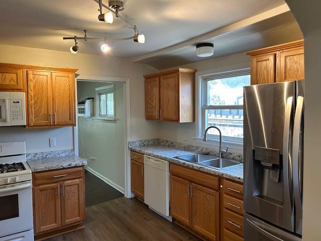 1464 Sheldon St, Saint Paul, MN 55108 - kitchen featuring white appliances, dark wood-style floors, brown cabinets, and light stone counters