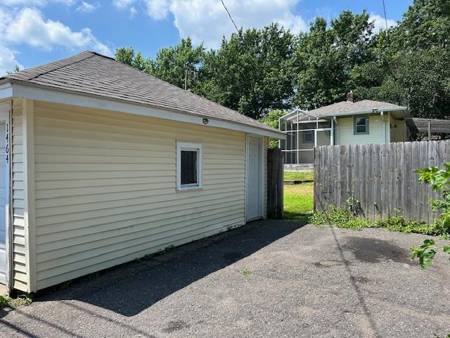 1464 Sheldon St, Saint Paul, MN 55108 - view of side of home featuring a shingled roof