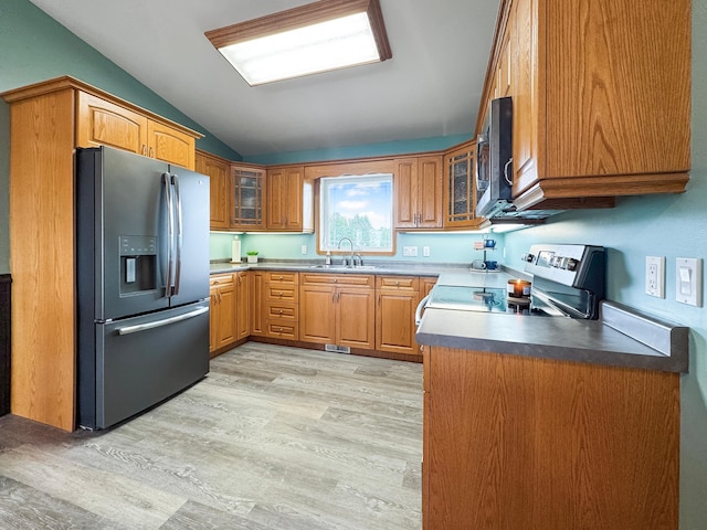 48285 229th Ave, Clearbrook, MN 56634 - kitchen with stainless steel appliances, lofted ceiling, light wood-style flooring, glass insert cabinets, and brown cabinetry