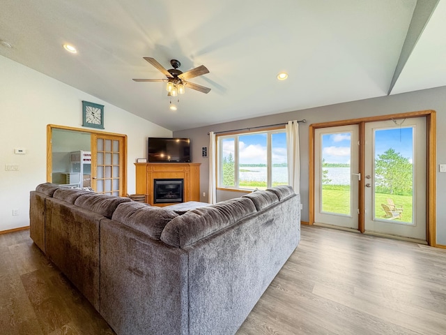 48285 229th Ave, Clearbrook, MN 56634 - living area with lofted ceiling, wood finished floors, a glass covered fireplace, ceiling fan, and recessed lighting