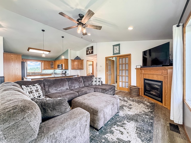 48285 229th Ave, Clearbrook, MN 56634 - living room with wood finished floors, vaulted ceiling, ceiling fan, and a glass covered fireplace