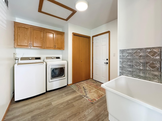 48285 229th Ave, Clearbrook, MN 56634 - laundry room with light wood finished floors, separate washer and dryer, and cabinet space