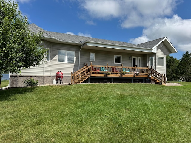 48285 229th Ave, Clearbrook, MN 56634 - back of house featuring a lawn, a wooden deck, stairs, and roof with shingles