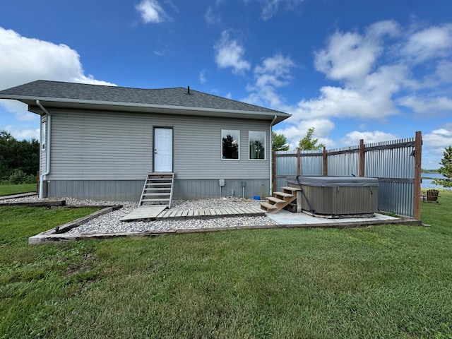 48285 229th Ave, Clearbrook, MN 56634 - back of property featuring a hot tub, a lawn, entry steps, and roof with shingles