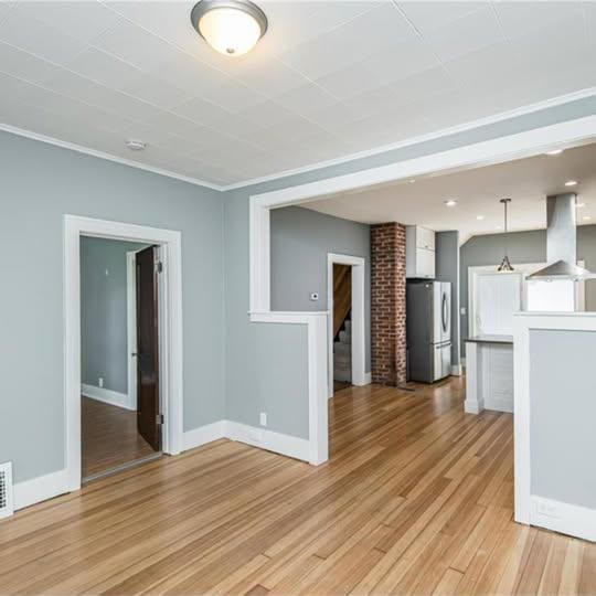 20 12th St NE, Rochester, MN 55906 - unfurnished living room featuring light wood finished floors and stairs