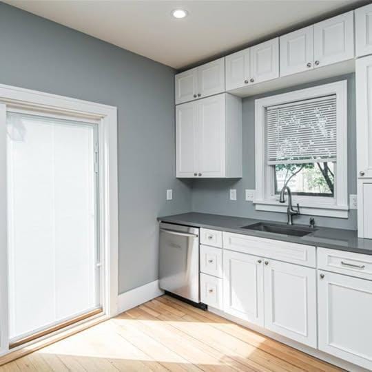 20 12th St NE, Rochester, MN 55906 - kitchen featuring dishwasher, dark countertops, light wood finished floors, white cabinets, and recessed lighting