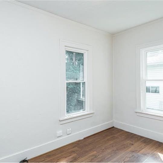 20 12th St NE, Rochester, MN 55906 - unfurnished room with ornamental molding and dark wood-style floors
