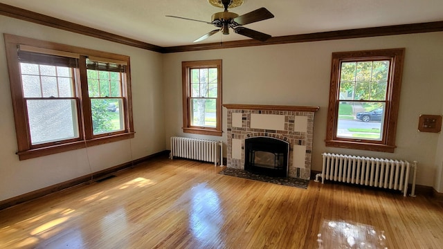 5015 17th Ave S, Minneapolis, MN 55417 - unfurnished living room with radiator, wood finished floors, crown molding, and a ceiling fan