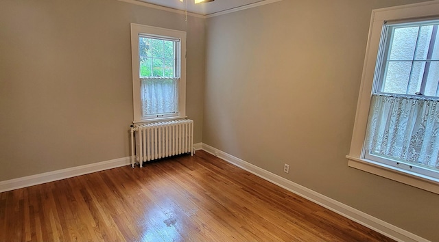 5015 17th Ave S, Minneapolis, MN 55417 - spare room with radiator heating unit, wood finished floors, ornamental molding, and ceiling fan