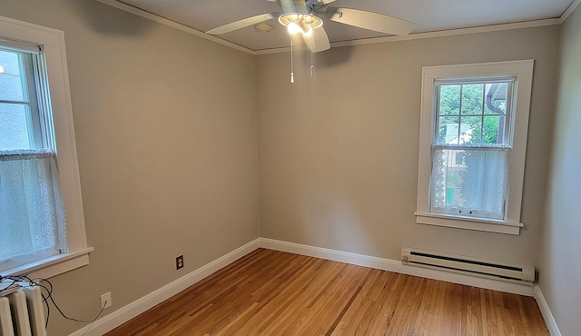 5015 17th Ave S, Minneapolis, MN 55417 - spare room with baseboard heating, ornamental molding, light wood-type flooring, and ceiling fan