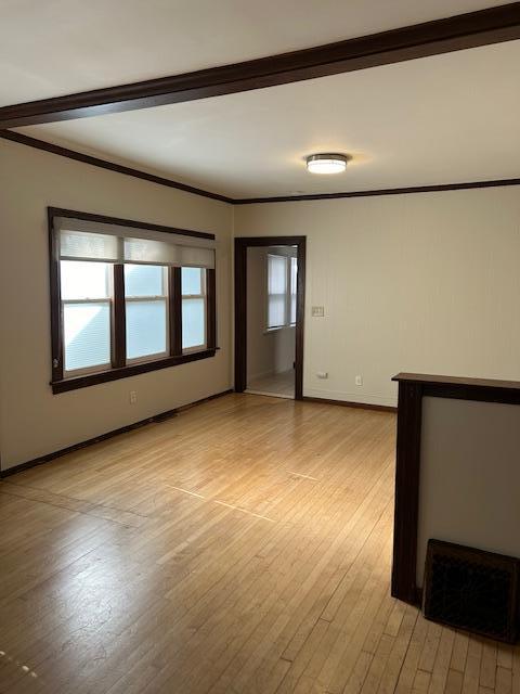 3022 32nd Ave S, Minneapolis, MN 55406 - unfurnished room with light wood finished floors and crown molding