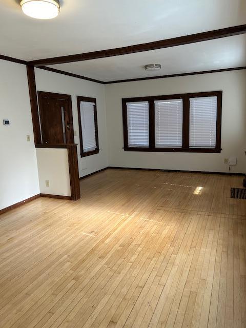 3022 32nd Ave S, Minneapolis, MN 55406 - spare room featuring light wood finished floors and crown molding