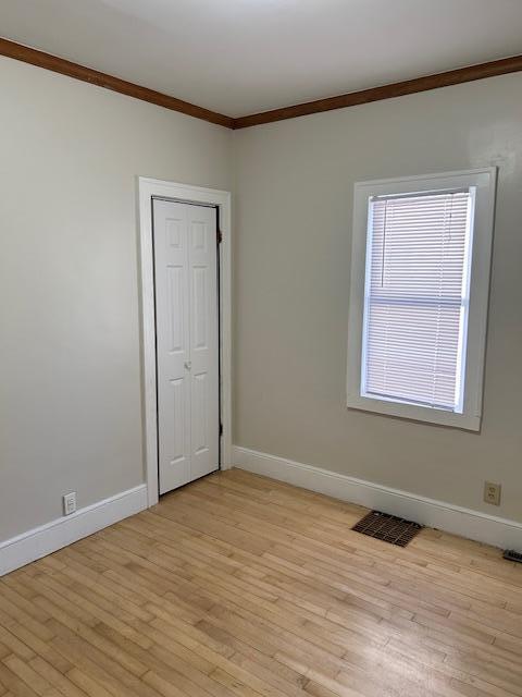 3022 32nd Ave S, Minneapolis, MN 55406 - empty room featuring crown molding and light wood finished floors