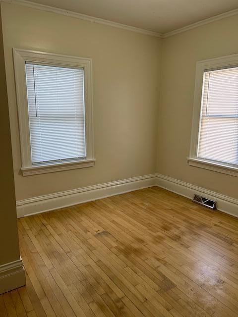 3022 32nd Ave S, Minneapolis, MN 55406 - unfurnished room with ornamental molding and light wood-style flooring