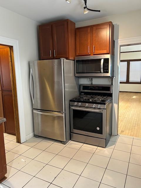 3022 32nd Ave S, Minneapolis, MN 55406 - kitchen with stainless steel appliances and light tile patterned floors
