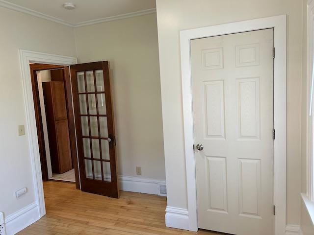 3022 32nd Ave S, Minneapolis, MN 55406 - unfurnished bedroom with light wood finished floors and ornamental molding