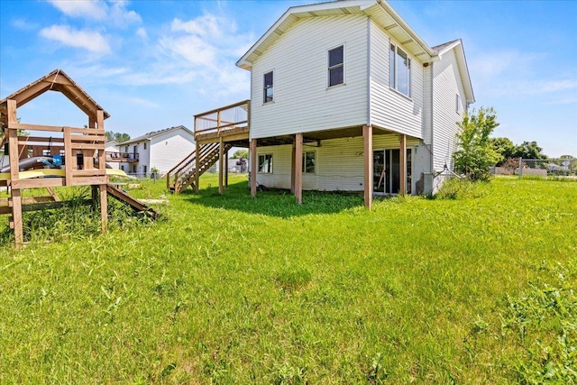 3455 Kahler Dr NE, Saint Michael, MN 55376 - back of property featuring stairs, a wooden deck, and a lawn