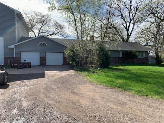 9225 Lake Blvd, Chisago City, MN 55013 - view of front of property featuring driveway, a front lawn, and a garage