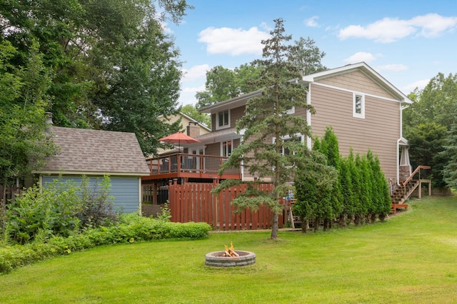 11735 52nd Ave N, Plymouth, MN 55442 - view of green lawn featuring an outdoor fire pit, stairway, and a deck