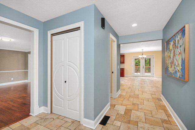11735 52nd Ave N, Plymouth, MN 55442 - corridor with stone tile floors, a chandelier, and french doors