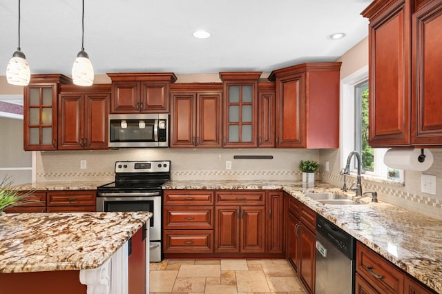 11735 52nd Ave N, Plymouth, MN 55442 - kitchen featuring appliances with stainless steel finishes, hanging light fixtures, backsplash, glass insert cabinets, and light stone counters
