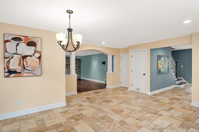 11735 52nd Ave N, Plymouth, MN 55442 - unfurnished room with arched walkways, stone tile flooring, ornate columns, a chandelier, and recessed lighting