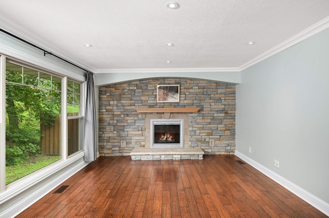 11735 52nd Ave N, Plymouth, MN 55442 - unfurnished living room with hardwood / wood-style flooring, a stone fireplace, a textured ceiling, and ornamental molding