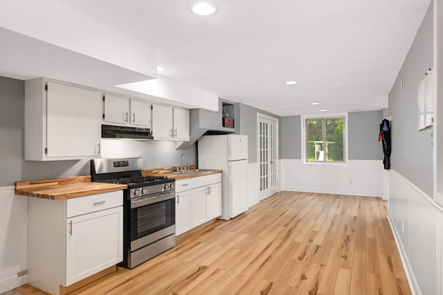 11735 52nd Ave N, Plymouth, MN 55442 - kitchen with gas range, freestanding refrigerator, a wainscoted wall, under cabinet range hood, and light wood-style flooring