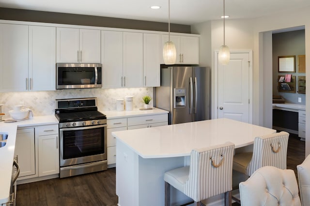 14620 106th Pl N, Maple Grove, MN 55369 - kitchen featuring appliances with stainless steel finishes, dark wood-type flooring, decorative backsplash, a breakfast bar, and recessed lighting