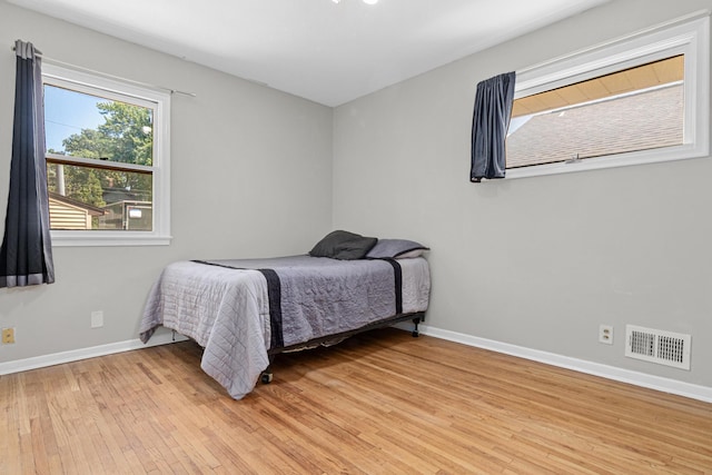 4405 6th St NE, Columbia Heights, MN 55421 - bedroom featuring light wood-style flooring and baseboards